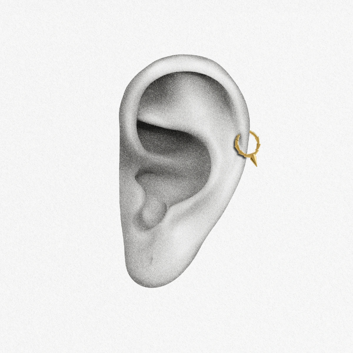 Gold Focused Spike Clicker shown on ear placement with central geometric spike design