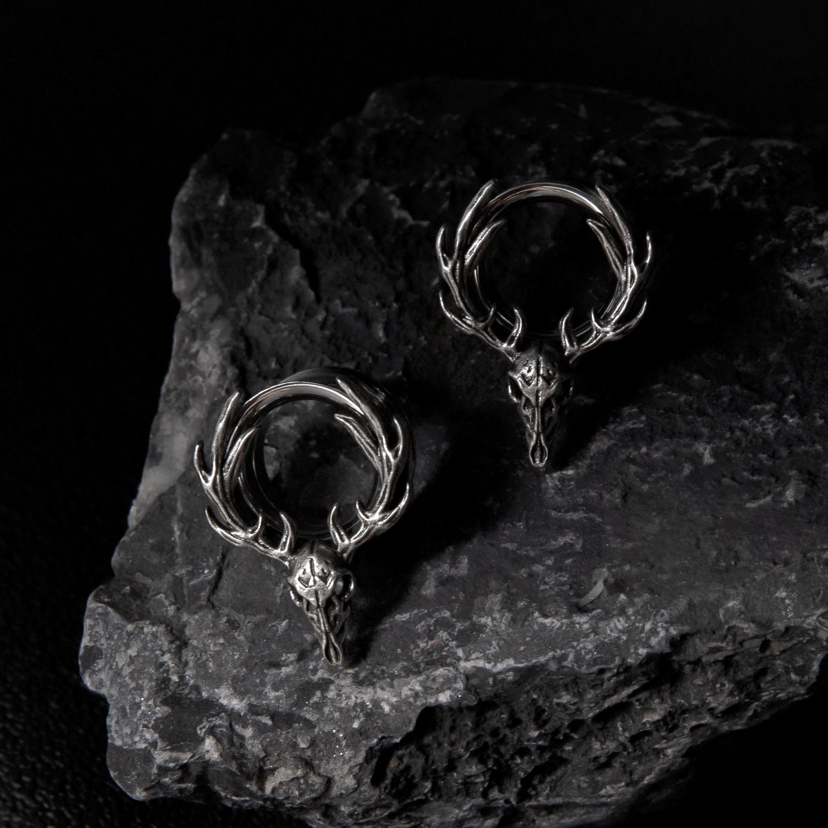 Pair of silver Forest Guardian tunnels displayed on dark stone