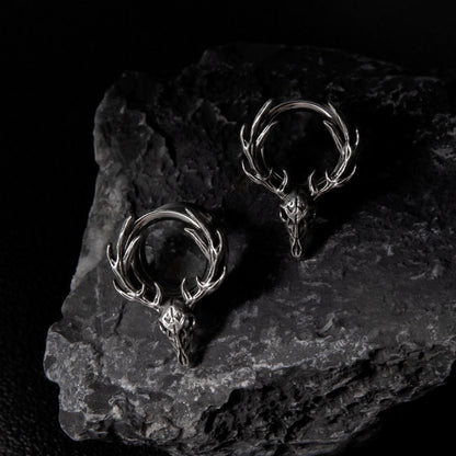 Pair of silver Forest Guardian tunnels displayed on dark stone