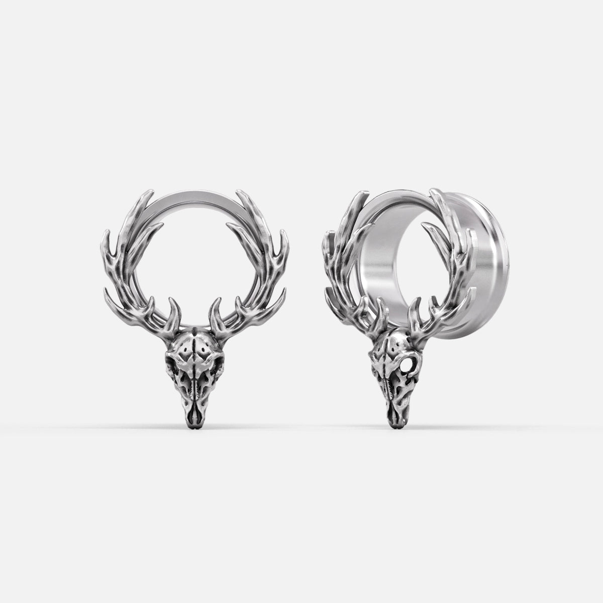 Silver-tone deer skull hoop earrings with antler details shown from front and side angles