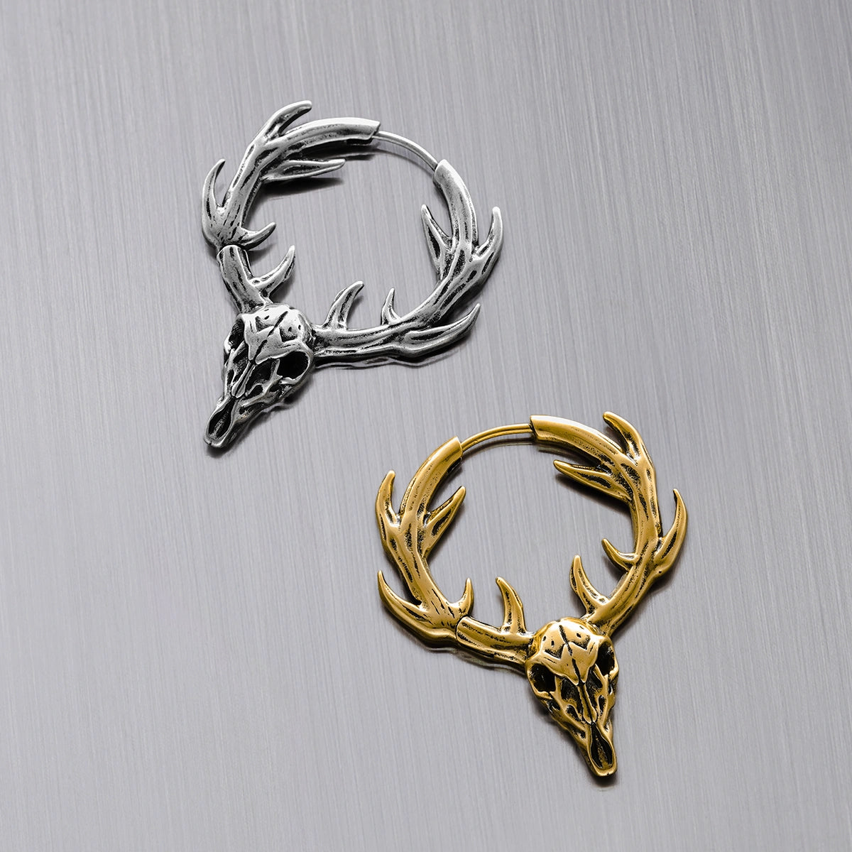 Silver and gold Forest Stag hoop earrings with antlered skull motifs