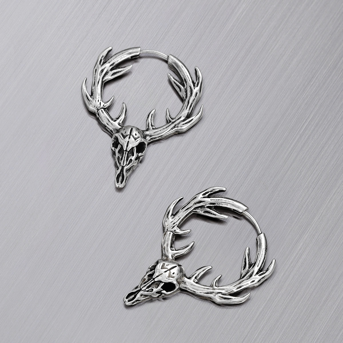 Pair of silver Forest Stag hoop earrings with antlered skull motifs