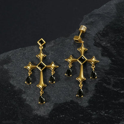 Gold Forsaken Vow Earrings displayed as a pair on black textured fabric.