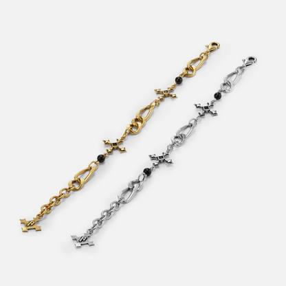Silver and gold Fractured Creed Bracelets extended side by side on white, highlighting the fractured link design.