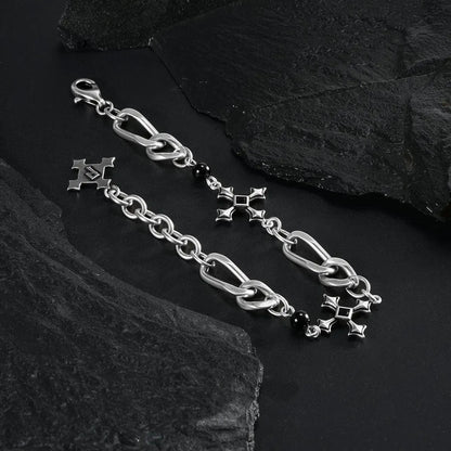 Silver Fractured Creed Bracelet arranged in a loop on black textured fabric.