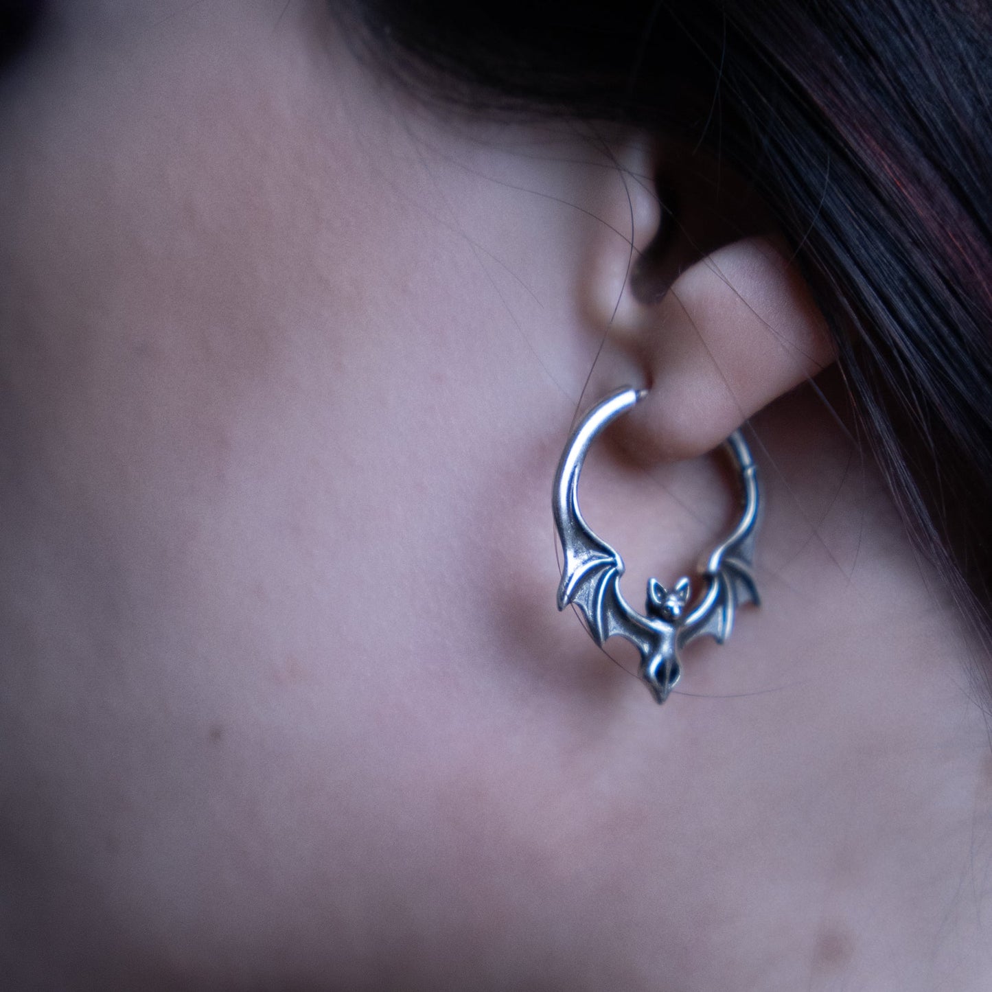 Silver Gothic Bat hoop earring worn in a stretched earlobe
