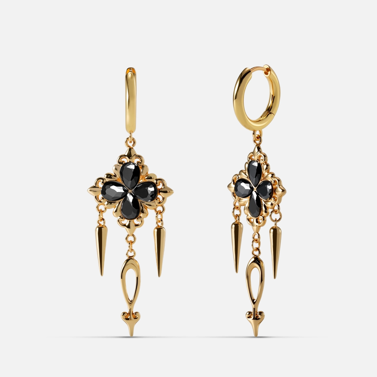 Gold-tone hoop earrings with black crystal cross motif and spike drops, front and side view