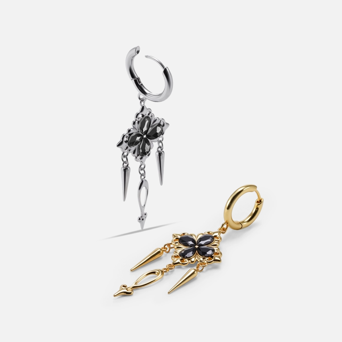 Gothic bloom earrings shown in silver-tone and gold-tone finishes with black crystal cross charms and spikes