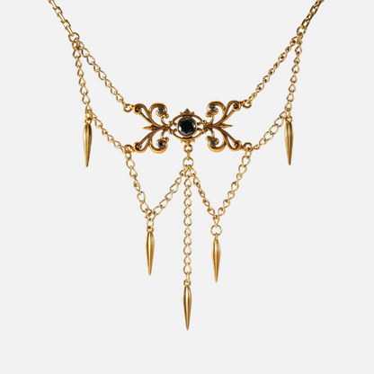 Gold-tone Gothic Cascade layered necklace with a black center stone and multiple spike drops