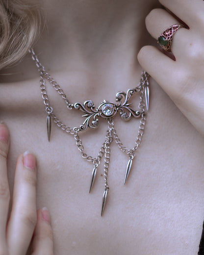 Silver Gothic Cascade Necklace worn close up, showing the ornate centre and hanging chains.