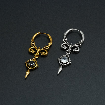 Gold and silver-tone Gothic Crest hoop earrings displayed side by side on a dark background