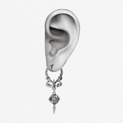 Silver-tone Gothic Crest hoop earring positioned on an illustrated earlobe to show the ornate drop length