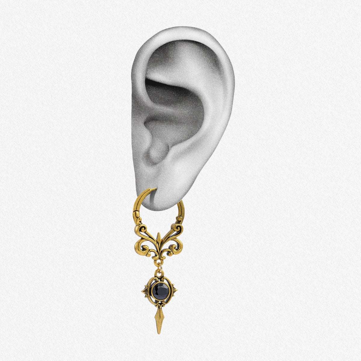 Gold-tone Gothic Crest hoop earring positioned on an illustrated earlobe with a black oval stone
