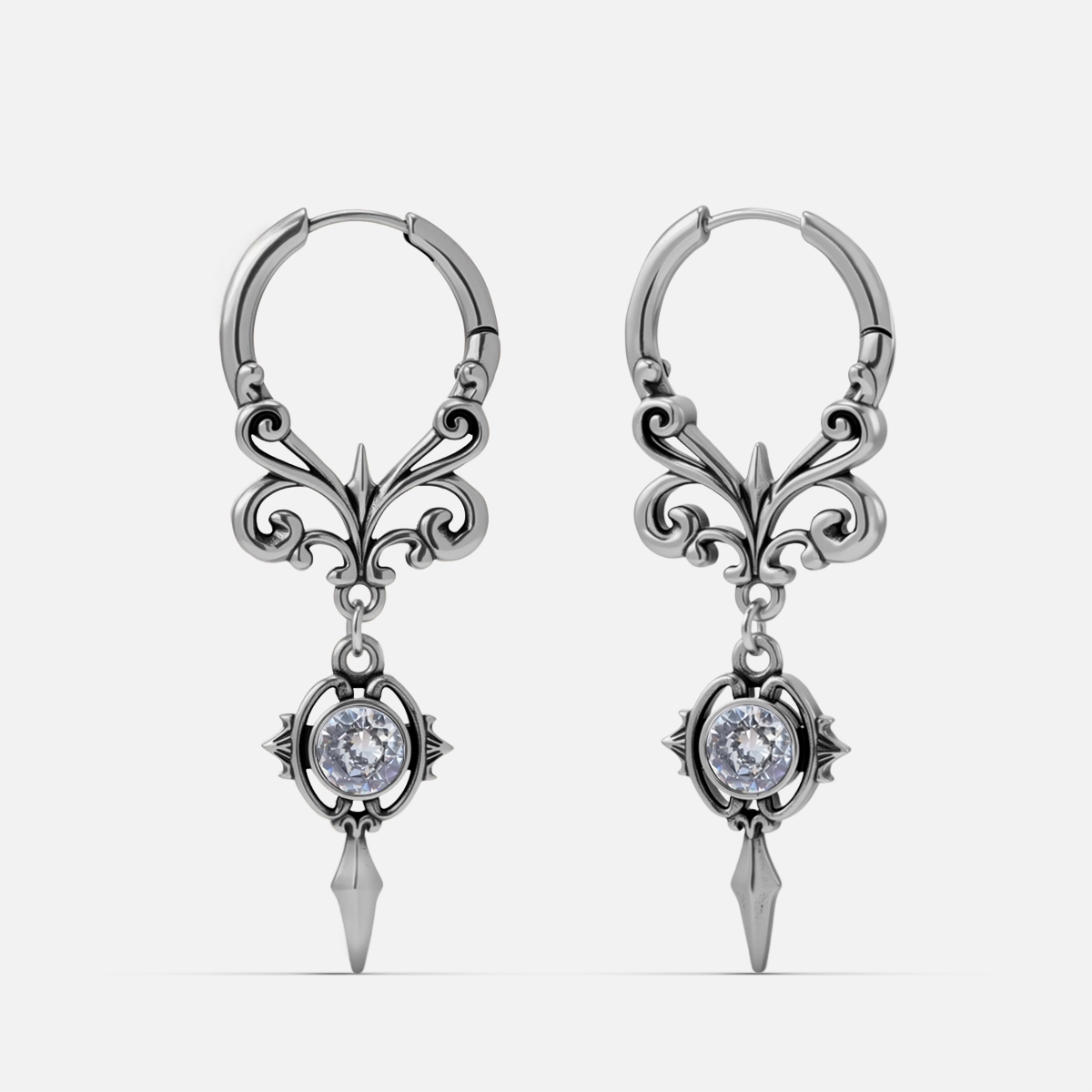 Silver-tone Gothic Crest hoop earrings with ornate scrollwork, clear stones, and pointed drops