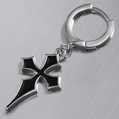 Close-up of silver Gothic Cross hoop earring with black cross pendant