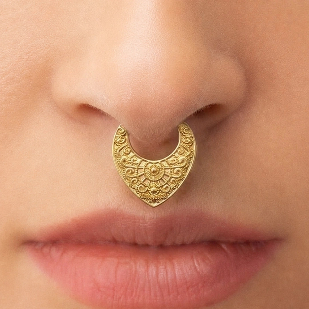Gold-tone Gothic Mandala Clicker worn as a septum ring, showing its detailed vintage-inspired pattern.