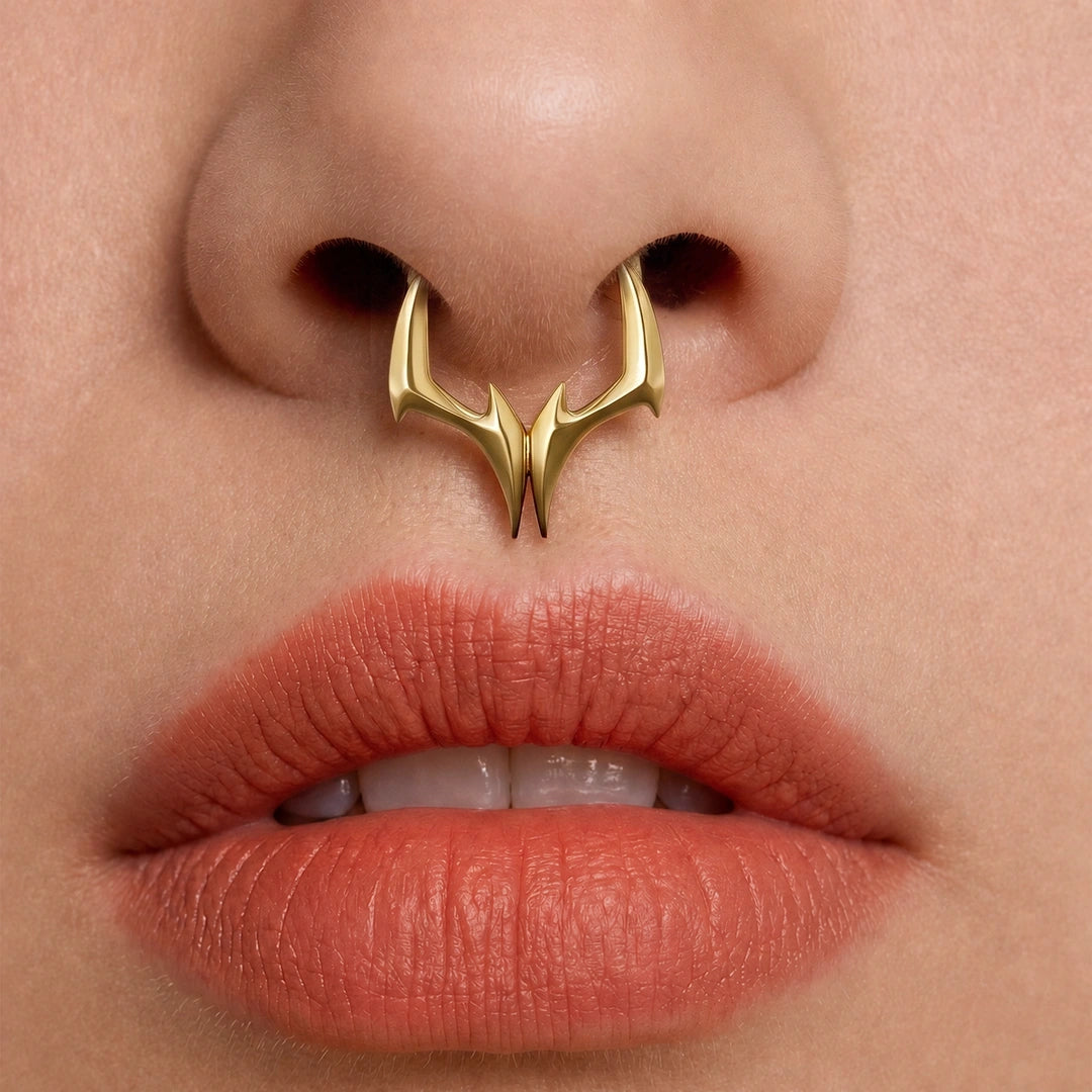 Gold-tone Gothic Talon Clicker worn as a septum ring, showing its bold talon-inspired silhouette.