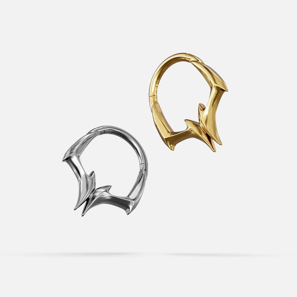 Silver- and gold-tone Gothic Talon Clickers displayed together from angled views to show the pointed profile.