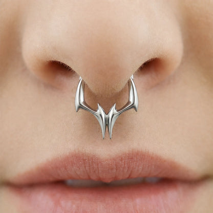 Silver-tone Gothic Talon Clicker worn as a septum ring, featuring a sleek pointed talon design.