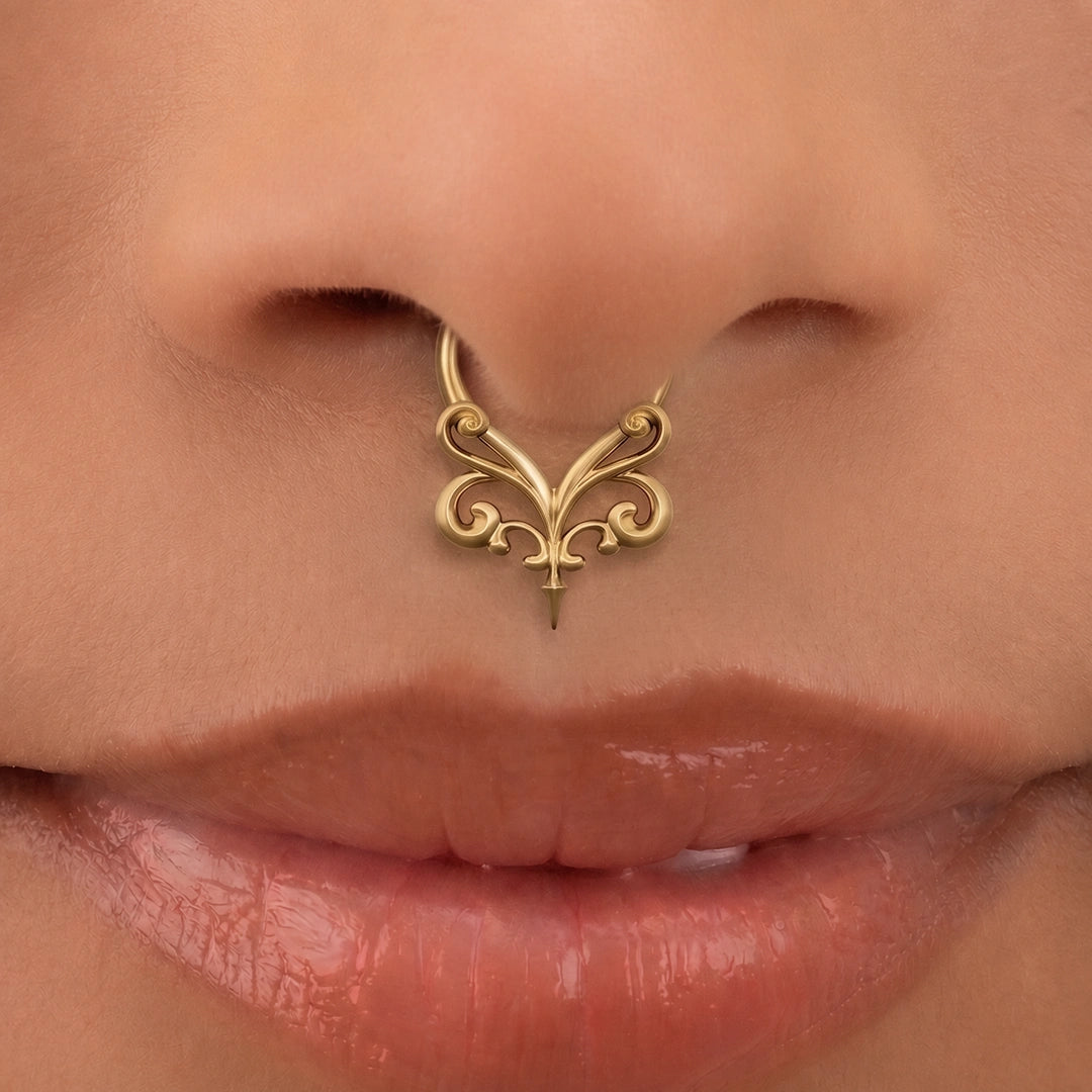 Gold-tone Gothic Vine Clicker worn as a septum ring, showing its decorative vintage-inspired design.
