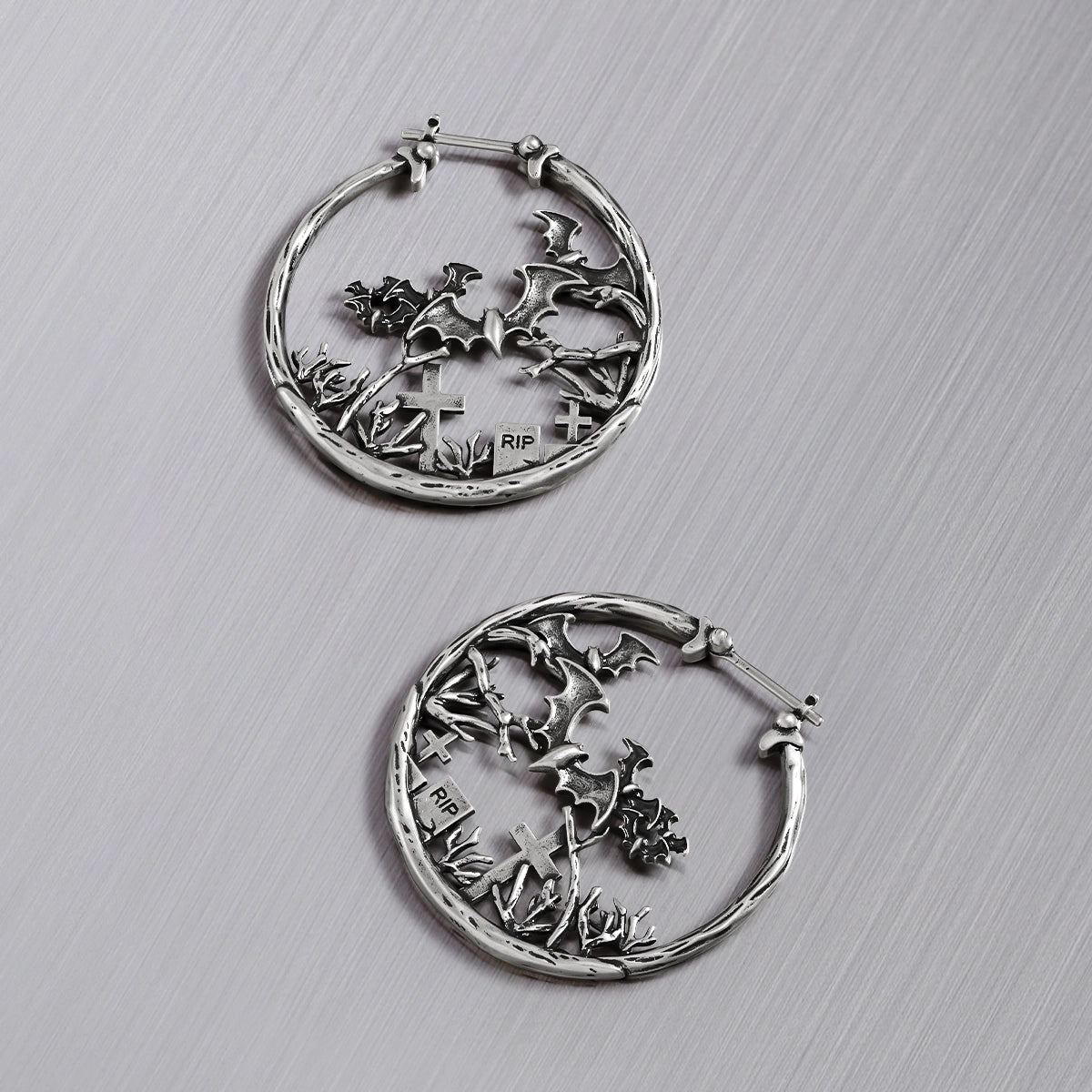 Pair of silver Graveyard Bat hoop earrings shown open and closed