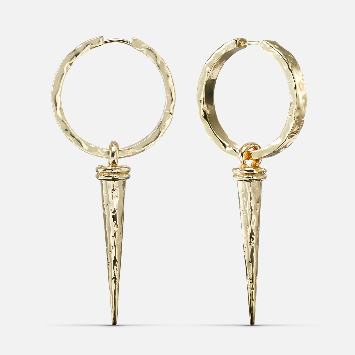 Pair of gold-tone hammered hoop earrings with tapered spike drops on a white background
