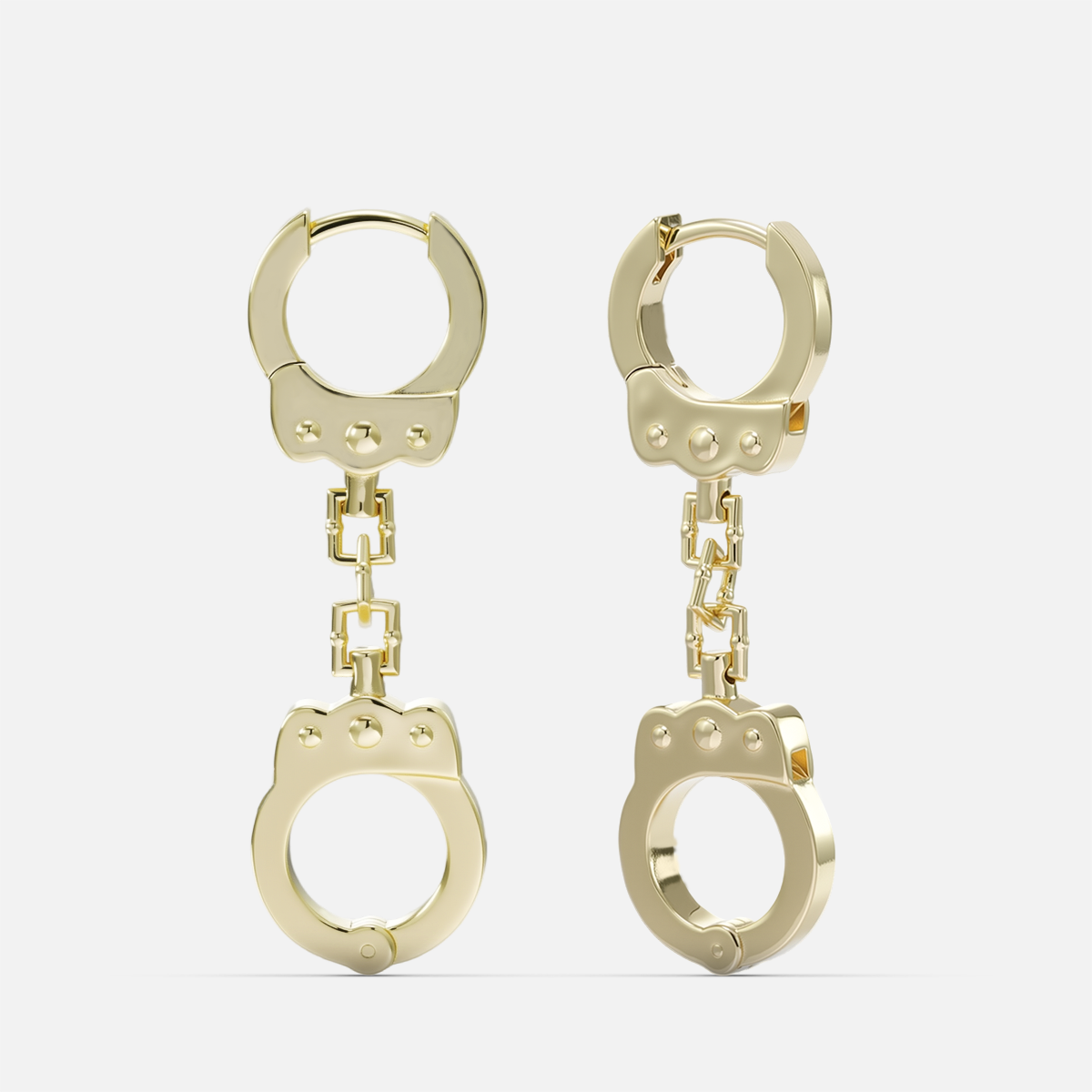 Gold-tone huggie earrings with a chain link connecting to a handcuff-shaped charm, front view