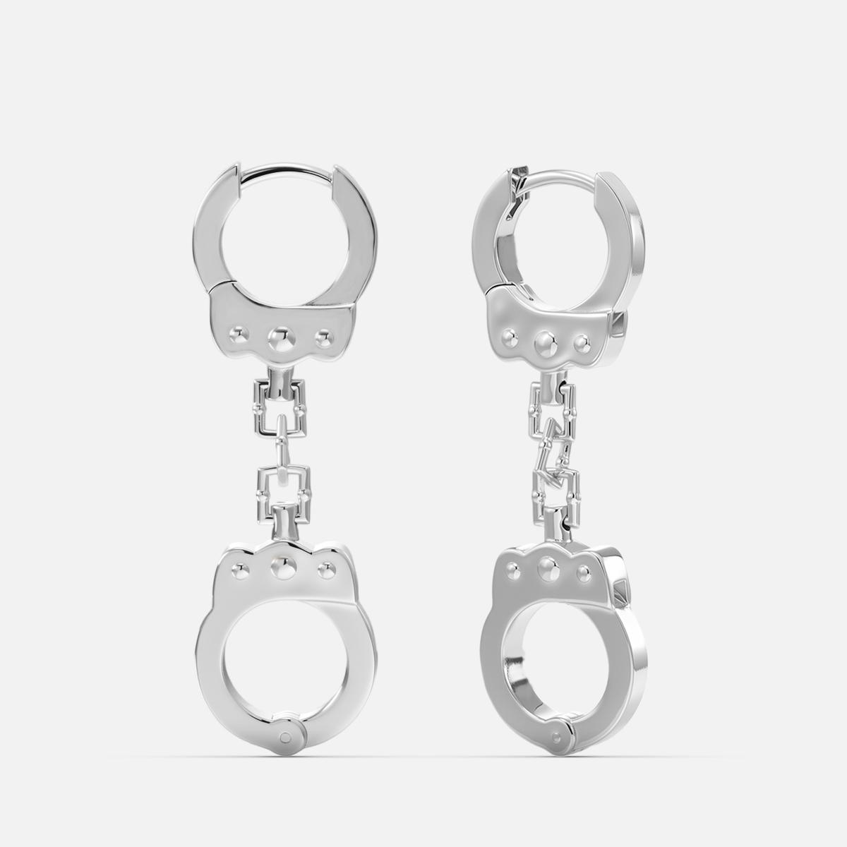 Silver-tone huggie earrings featuring a chain link and handcuff-shaped charm, front view