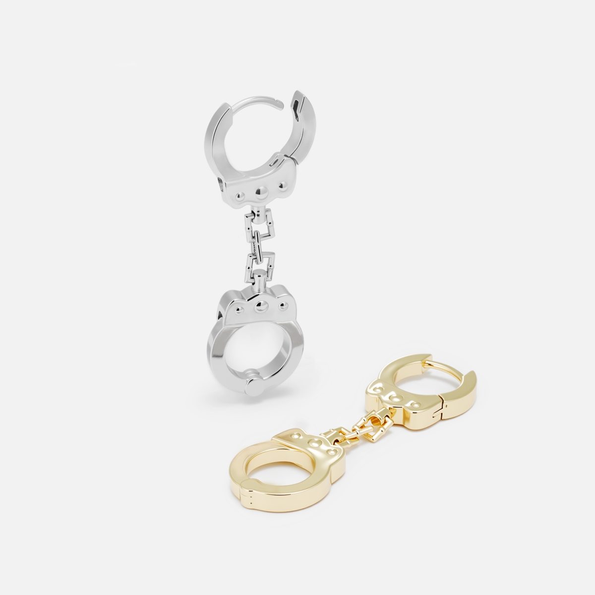 Silver-tone and gold-tone handcuff chain earrings displayed side by side on a plain background