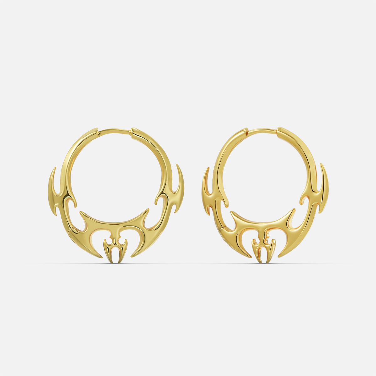 Gold-tone hoop earrings pair featuring a flame or wing motif along the bottom curve, front view
