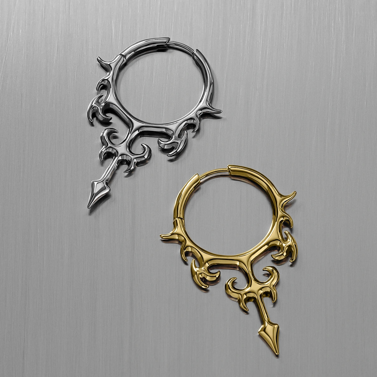 Silver and gold Hellflame Blade hoop earrings shown open and lying flat