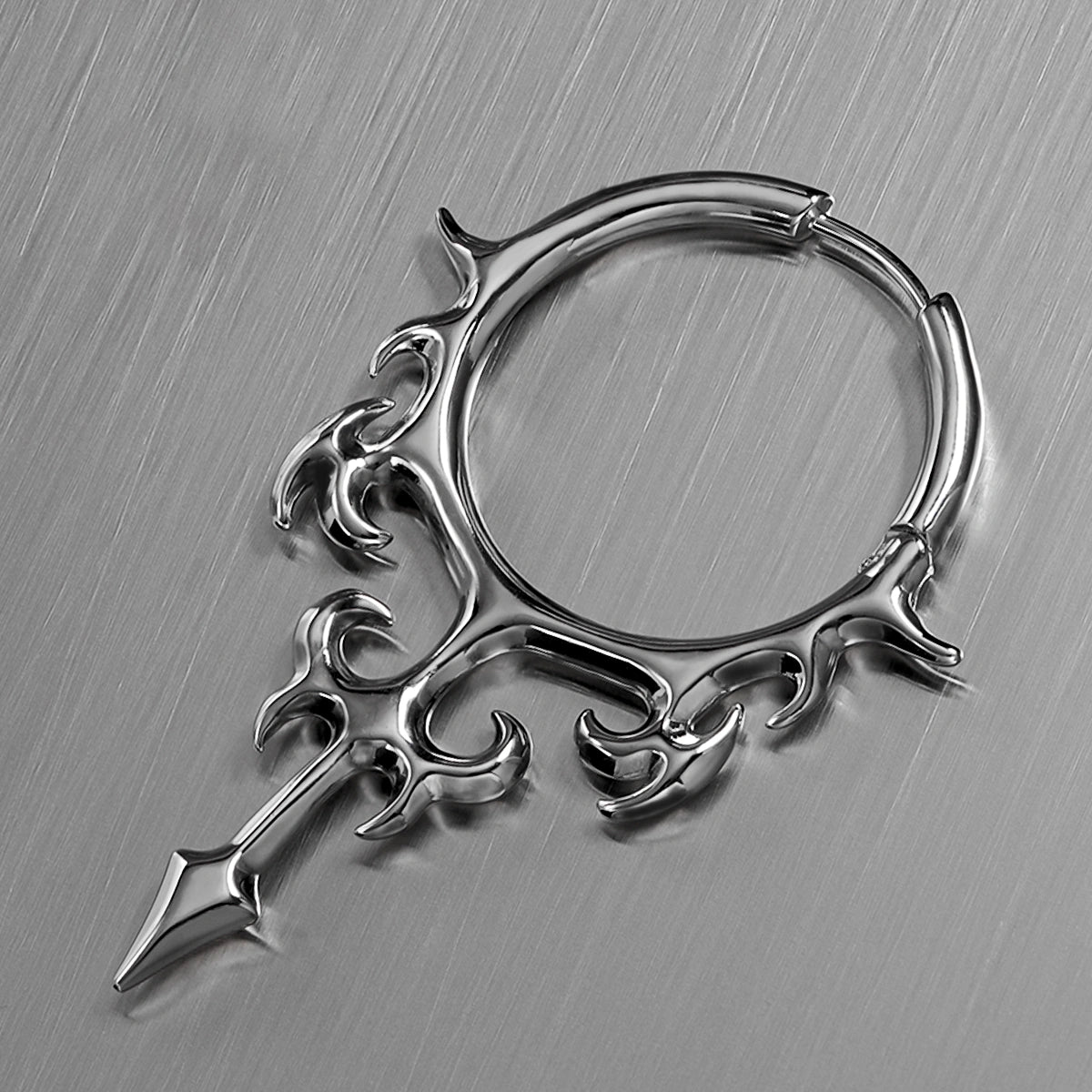 Close-up of silver Hellflame Blade hoop earring with flame scrollwork