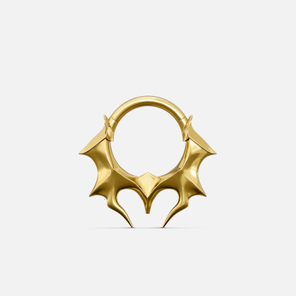 Gold-tone Infernal Horn Clicker with sharp symmetrical horn accents and an angular lower silhouette.
