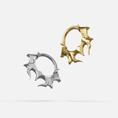 Silver- and gold-tone Infernal Horn Clickers displayed together to compare the two finishes.