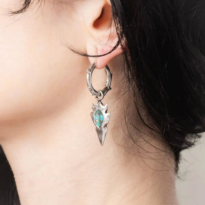 Model wearing silver Knapped Stone Earrings with turquoise arrowhead drops and hammered hoop design