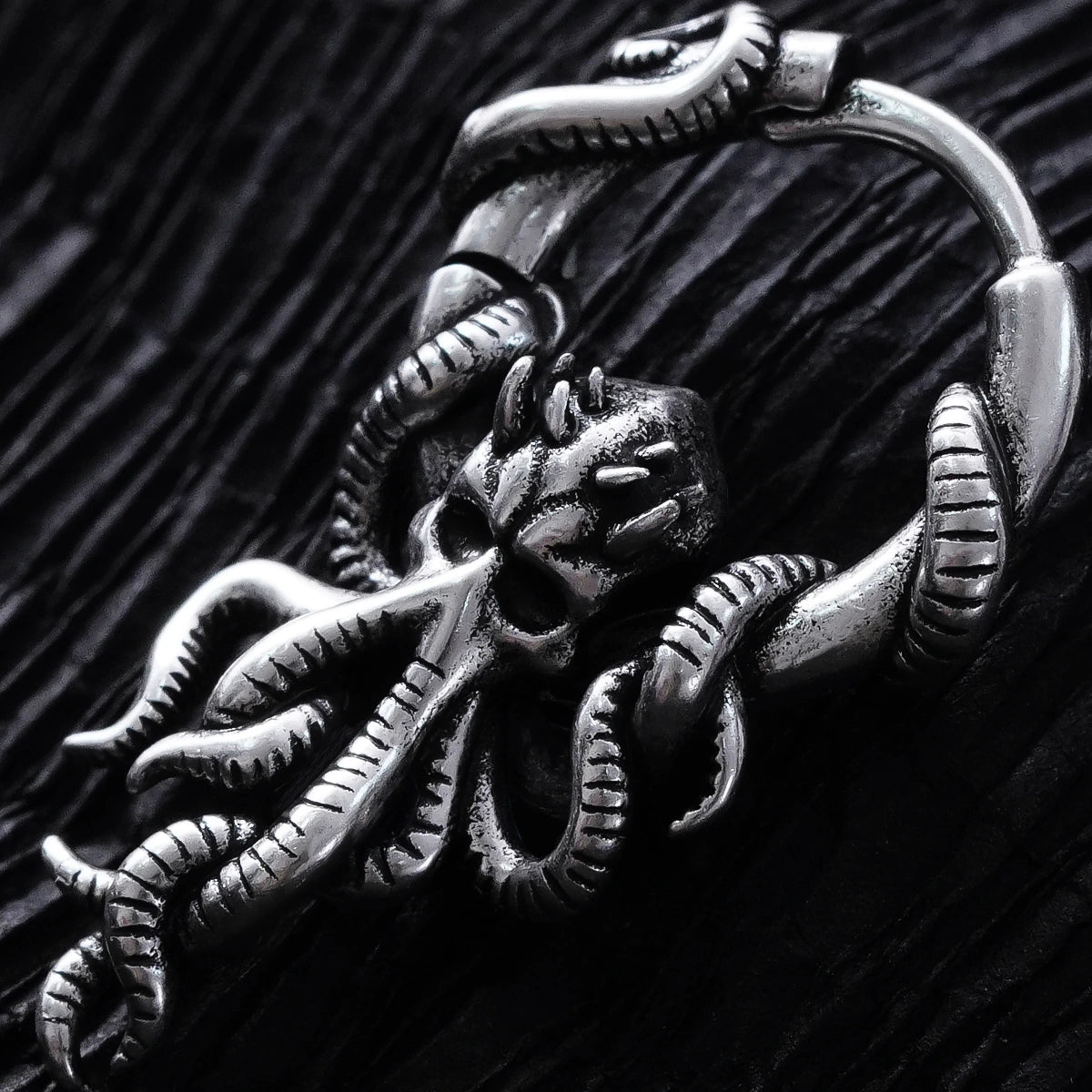 Close-up of silver Kraken Mystique hoop earring with curled tentacle details