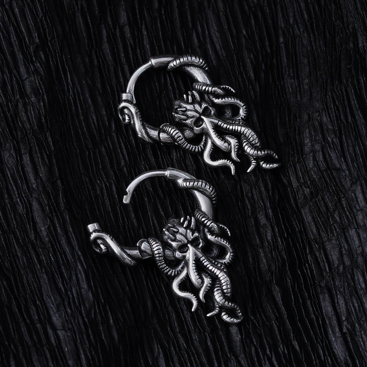Pair of silver Kraken Mystique hoop earrings with dangling tentacled figures