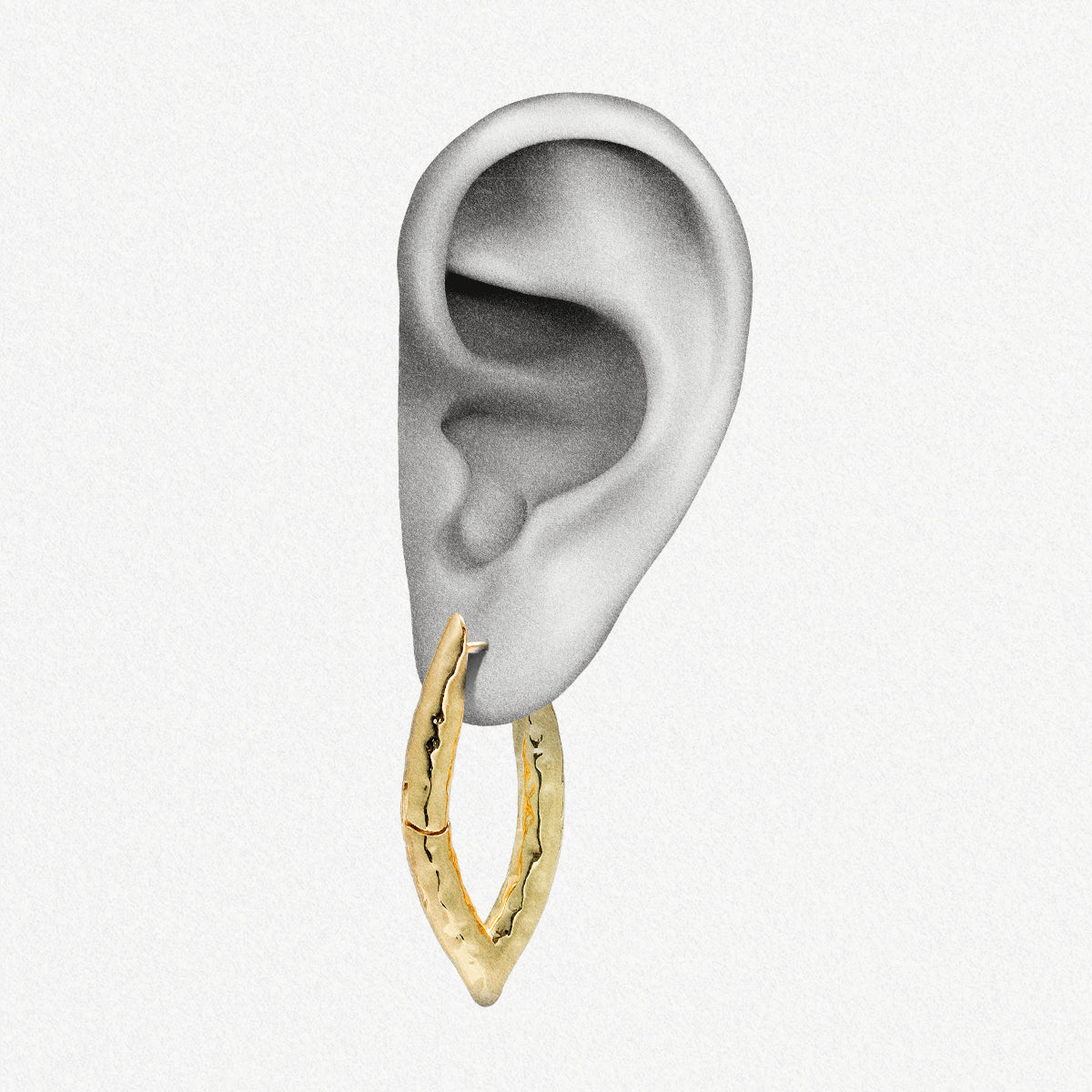 Gold-tone liquid metal hoop earring with hammered texture shown worn on an ear model