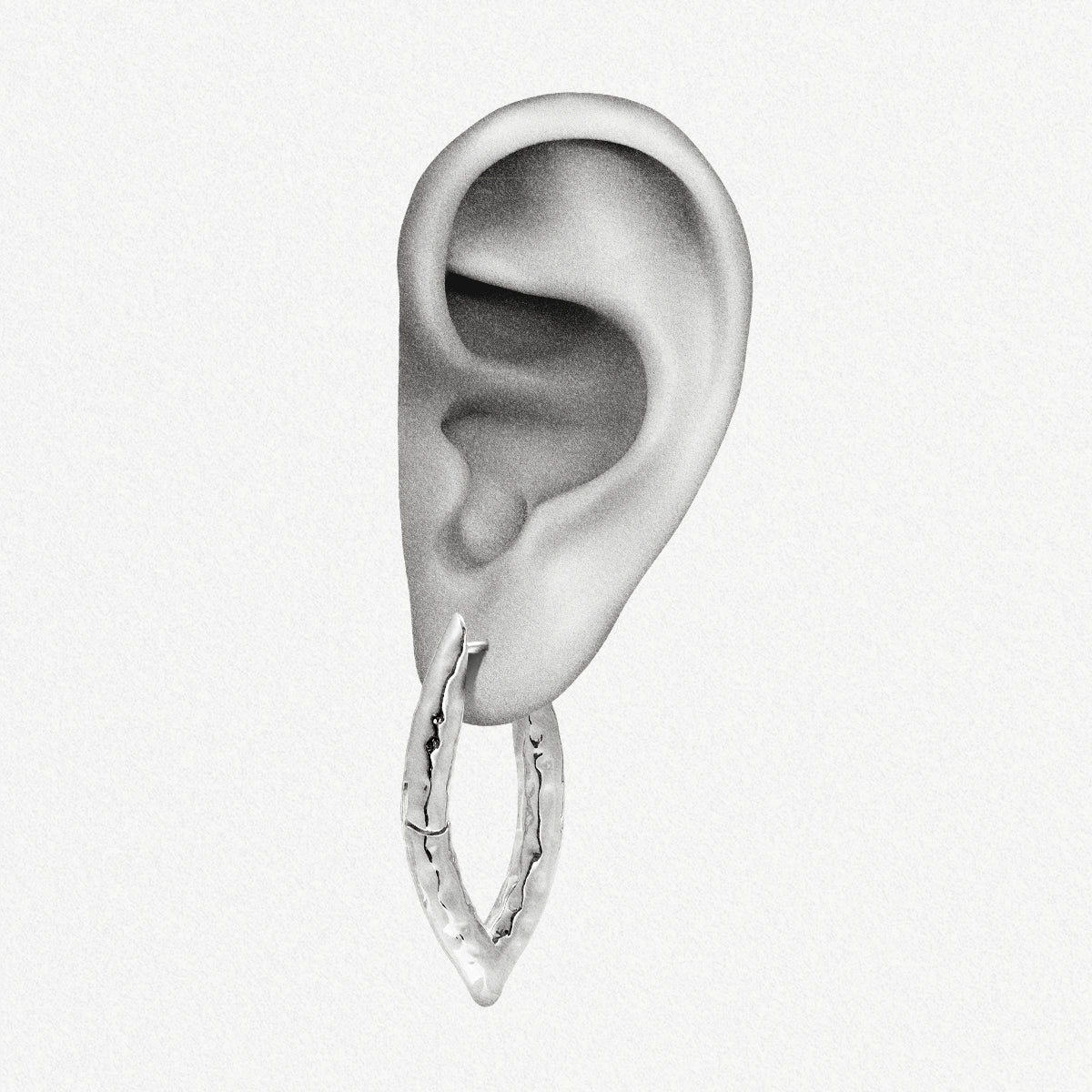 Silver-tone liquid metal hoop earring with hammered texture shown worn on an ear model