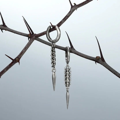 Longinus Abyss Stinger Earrings in 925 sterling silver, pair hanging from thorn branches to highlight the segmented spine tex