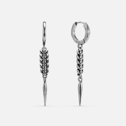 Silver-tone huggie hoop earrings with a spine-like segmented drop ending in a tapered spike