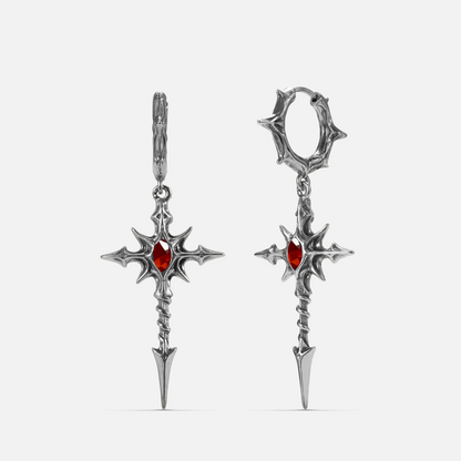 Pair of silver-tone dagger cross earrings with red gemstone center and thorn-textured hoops