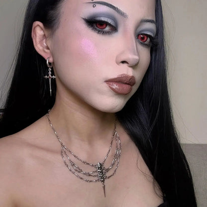 Longinus Godpiercer Earrings in 925 sterling silver, worn in a gothic portrait with red contact lenses, black hair, and layer