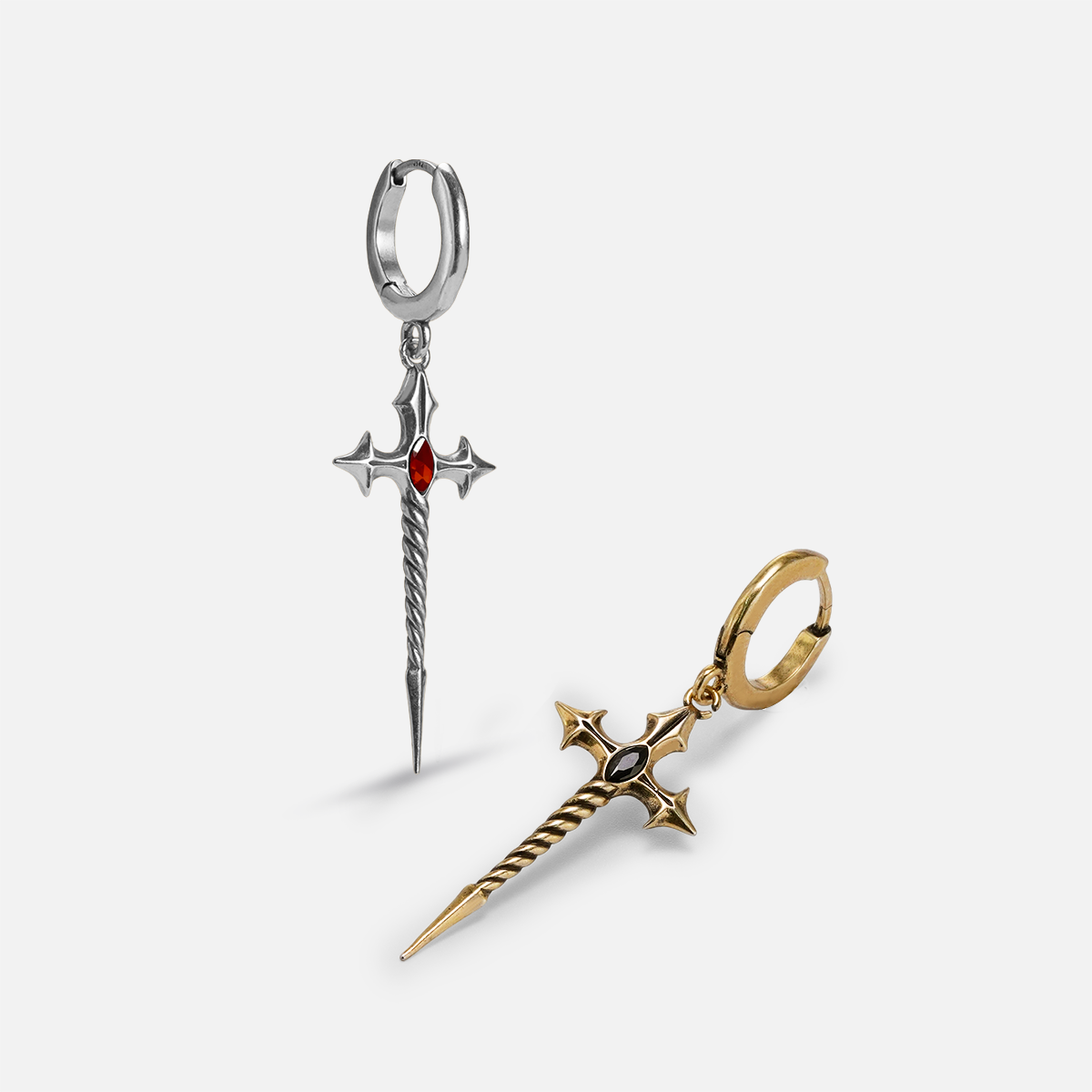 Silver and gold-tone Longinus Godpiercer hoop earrings arranged upright and flat with sword pendants