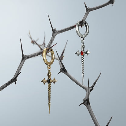 Gold and silver-tone Longinus Godpiercer hoop earrings with red accents hanging from thorn branches