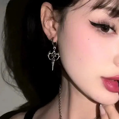 Longinus Halo Piercer Earrings in 925 sterling silver, worn in a close half-face portrait with black hair and winged eyeliner