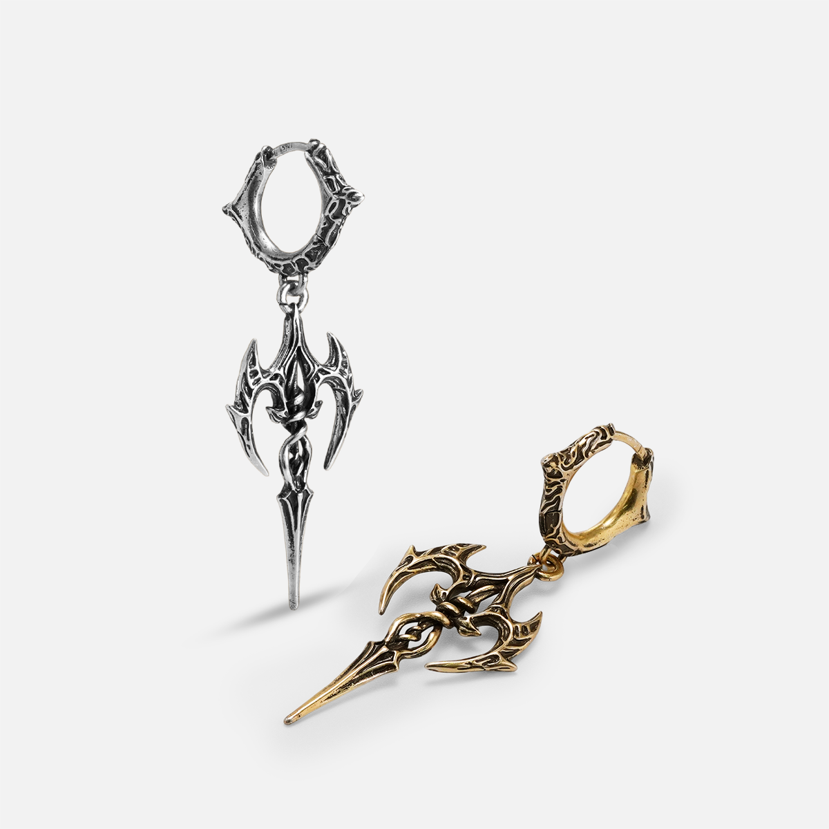 Silver and gold Longinus Halo Piercer hoop earrings with ornate pointed blade pendants