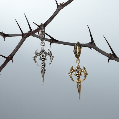 Silver and gold Longinus Halo Piercer earrings hanging together on thorn branches
