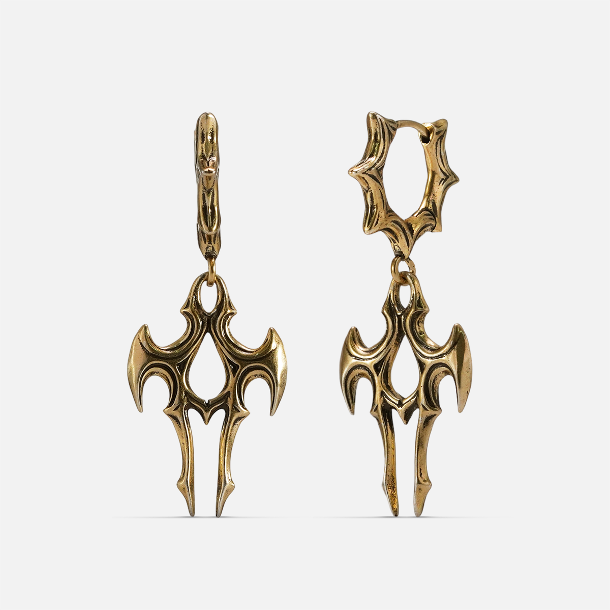 Pair of gold-tone talon shaped drop earrings with spiked hoop closures, displayed on a plain background