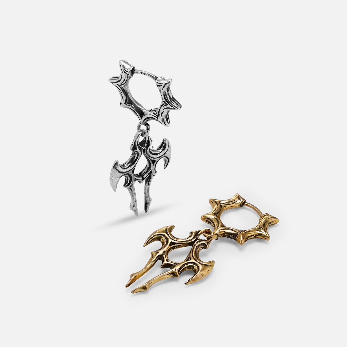 Silver and gold Longinus Judgment Talon earrings shown upright and lying flat